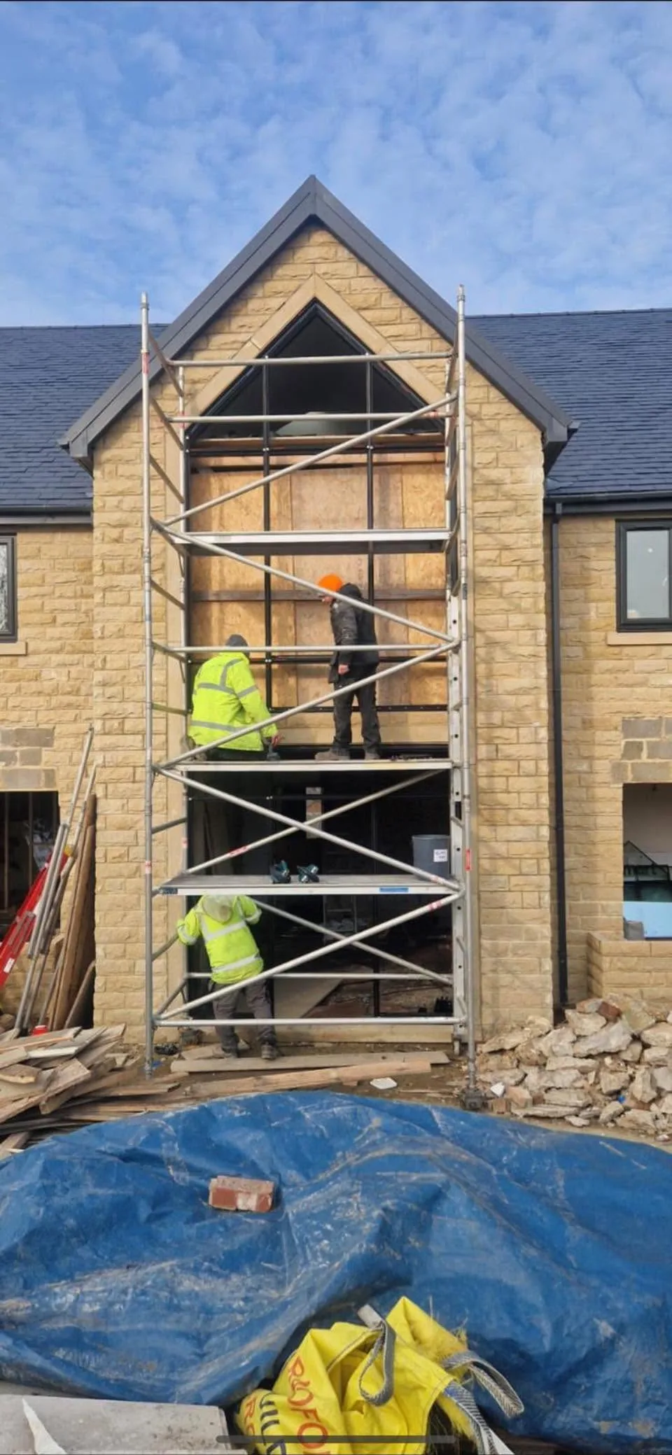MBE team installing a full-height aluminium-framed glazed opening